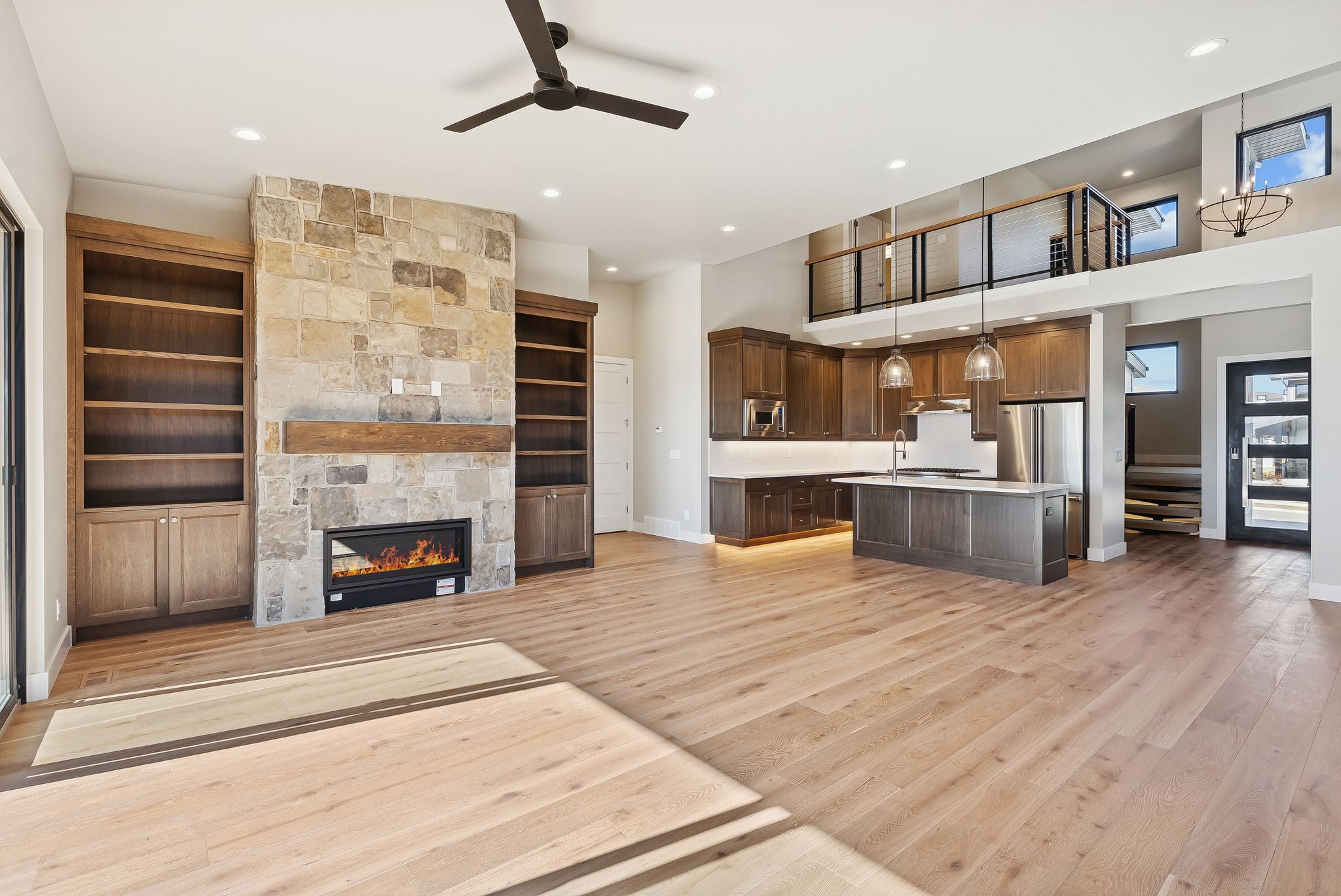 Open-concept living space with light wood-finish flooring