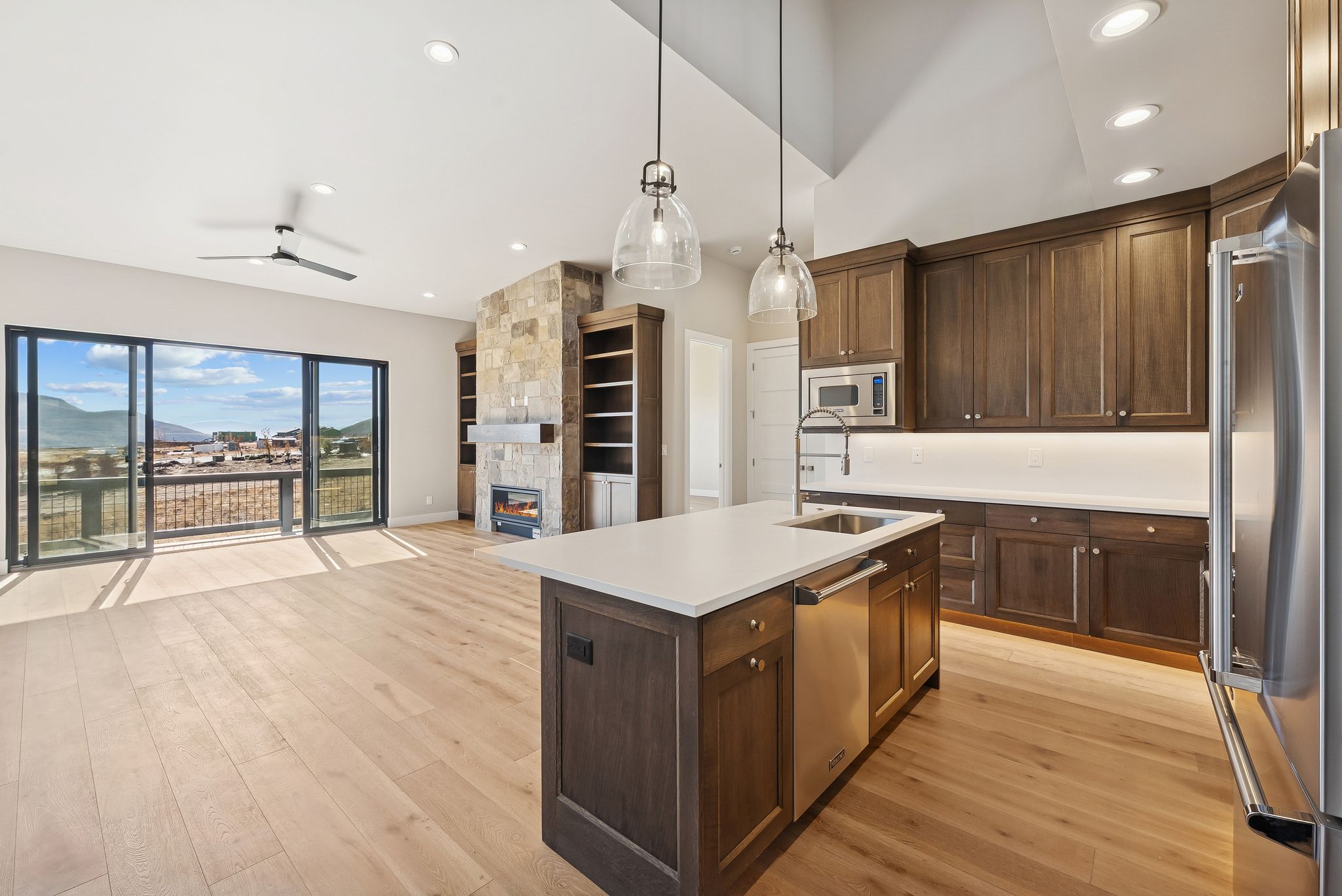 Open-concept living space with light wood-finish flooring