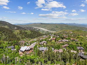 Expansive mountain landscape featuring residential properties nestled among mature trees