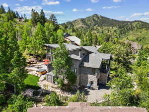 Mountain-side residence featuring a multi-level design with stone and siding exterior