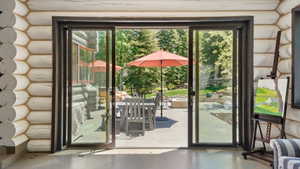 Sliding glass doors opening to an outdoor patio with stone paving