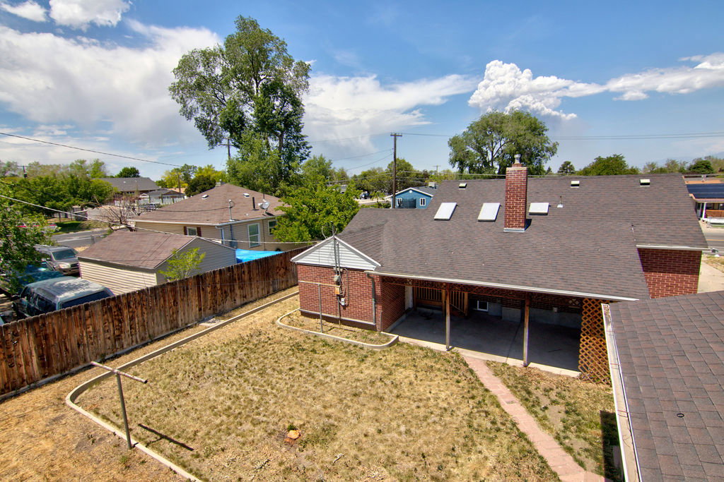 Rear exterior featuring a covered patio with exposed wood columns