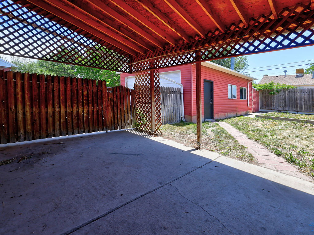 Carport with concrete slab and lattice wood ceiling
