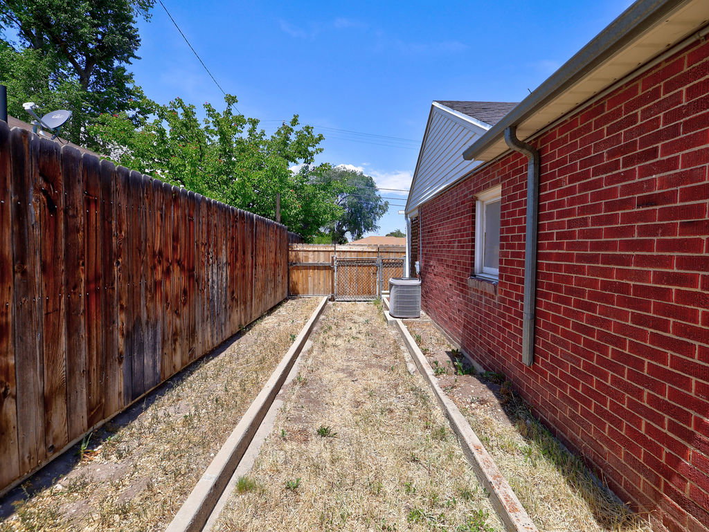 Exterior brick siding with a white-framed window