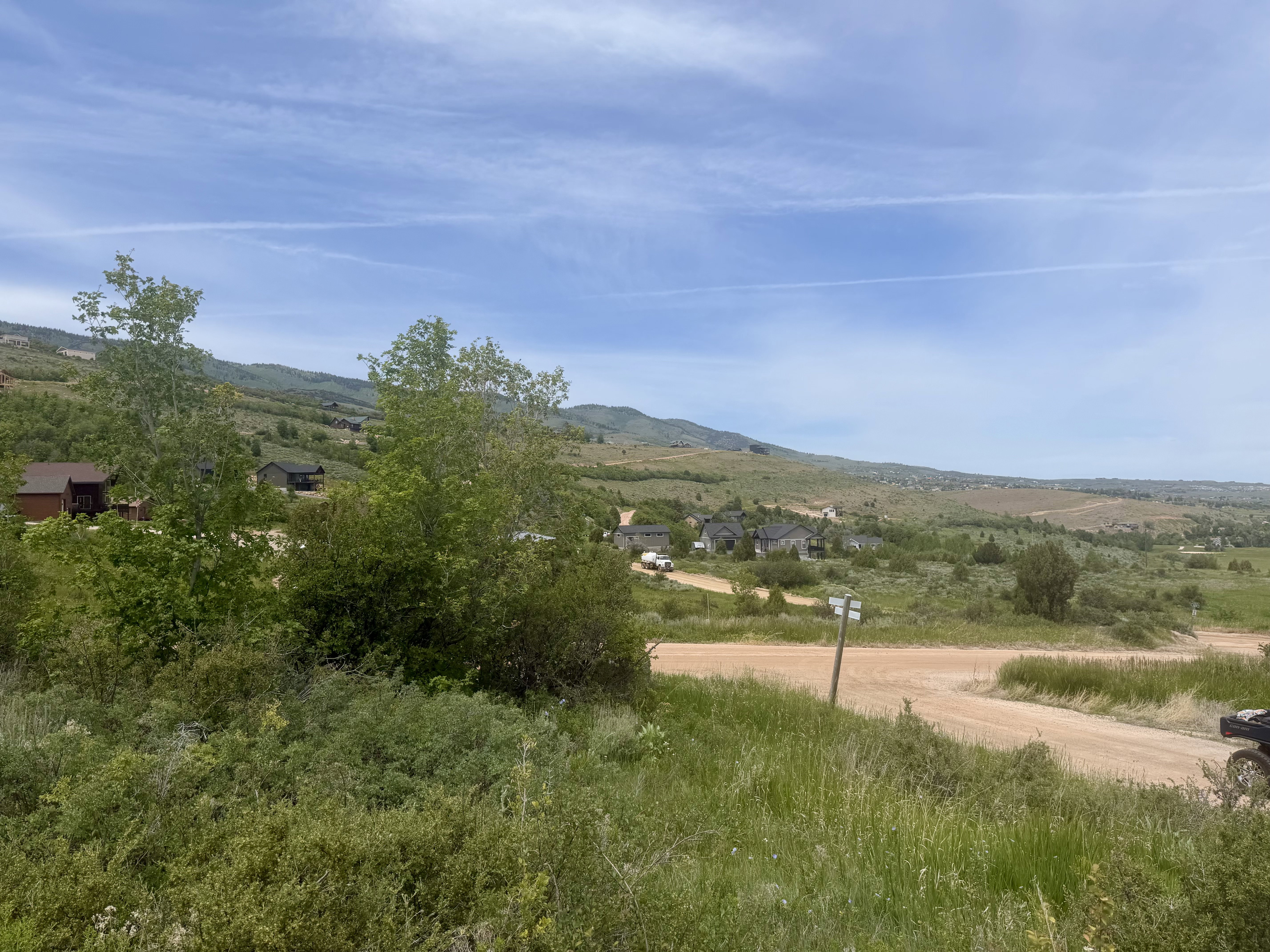 Expansive landscape with distant homes nestled among rolling hills