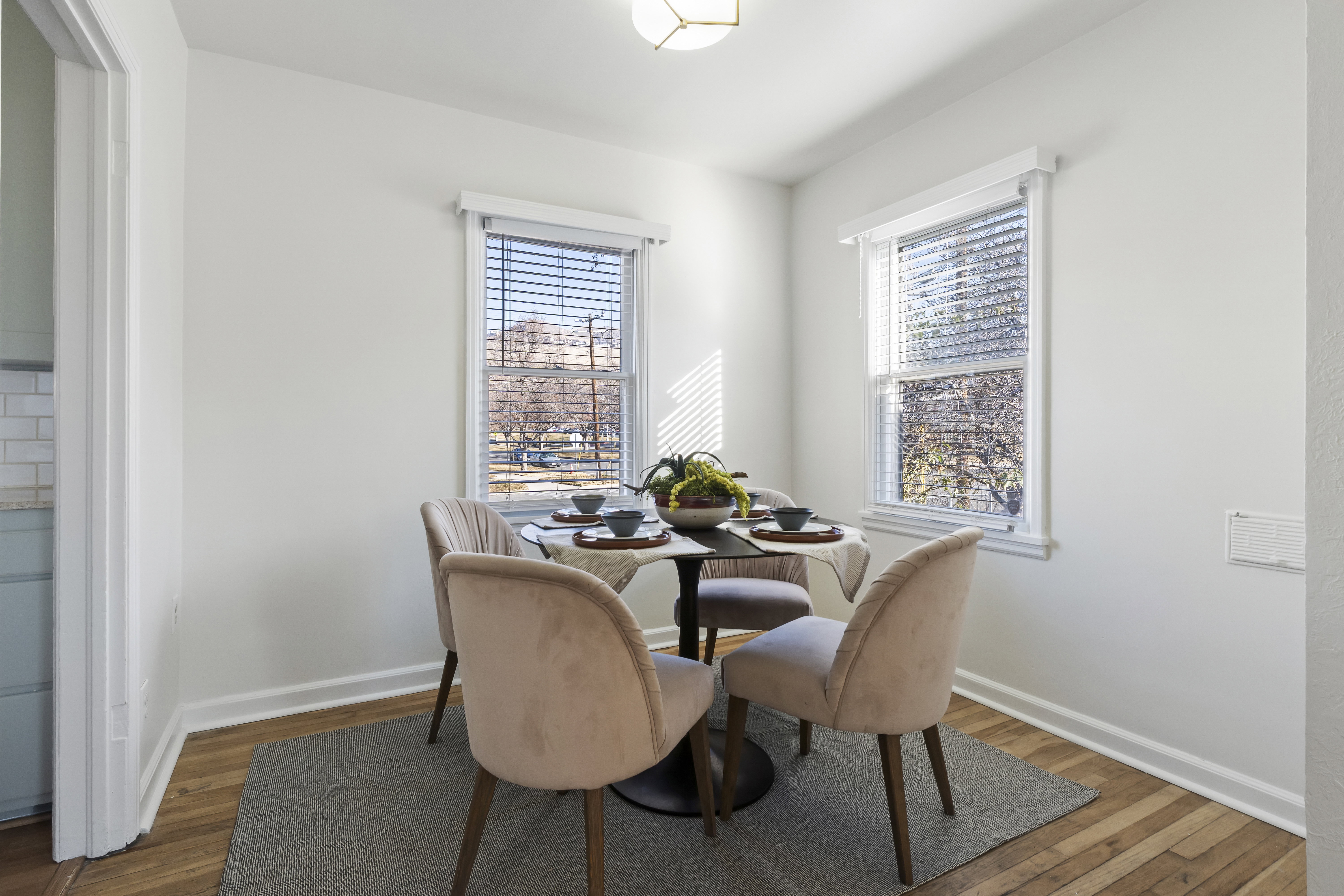 Bright dining area featuring wood-finish flooring and white baseboards