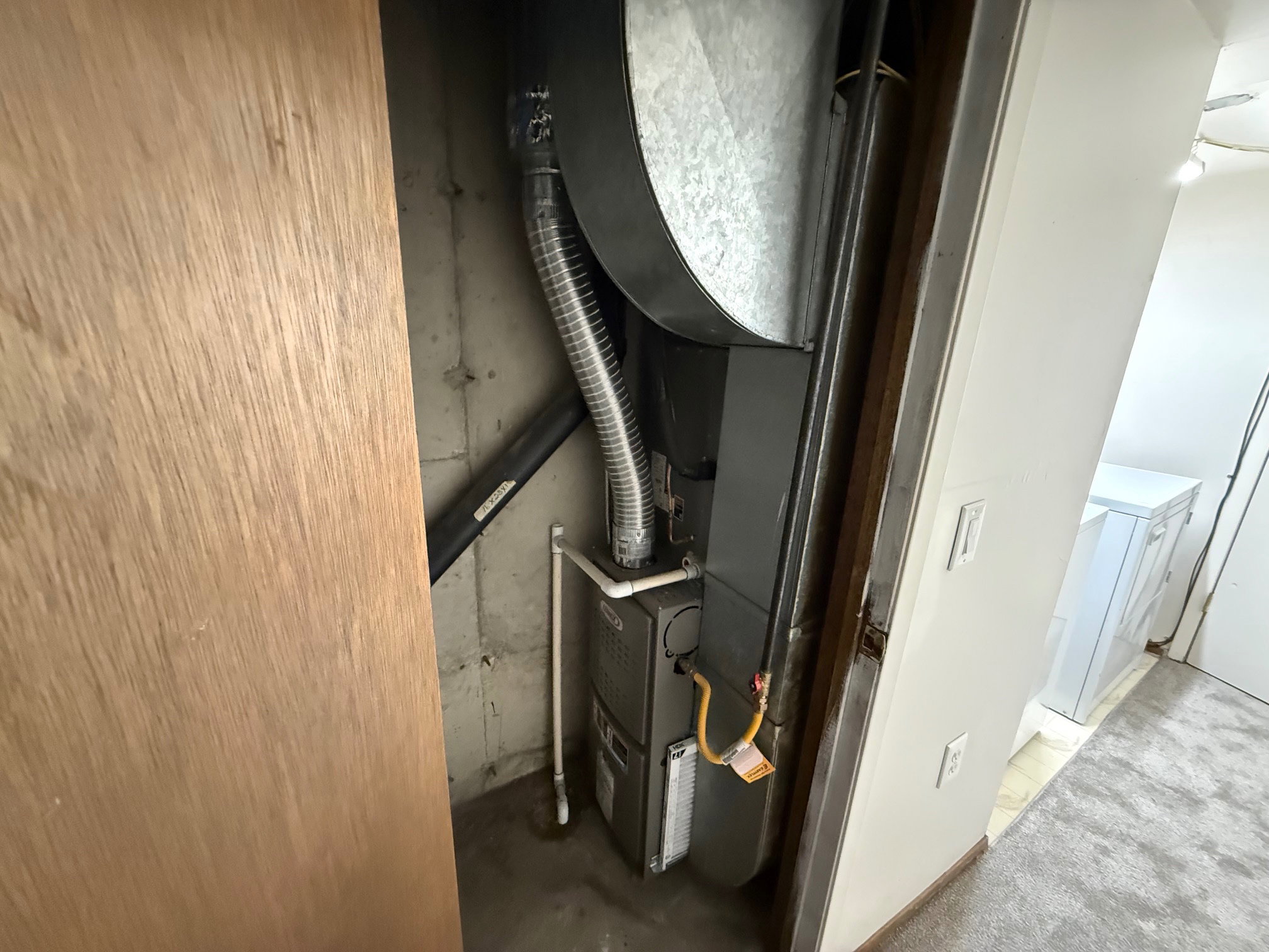 Utility closet featuring a newer HVAC (2023)