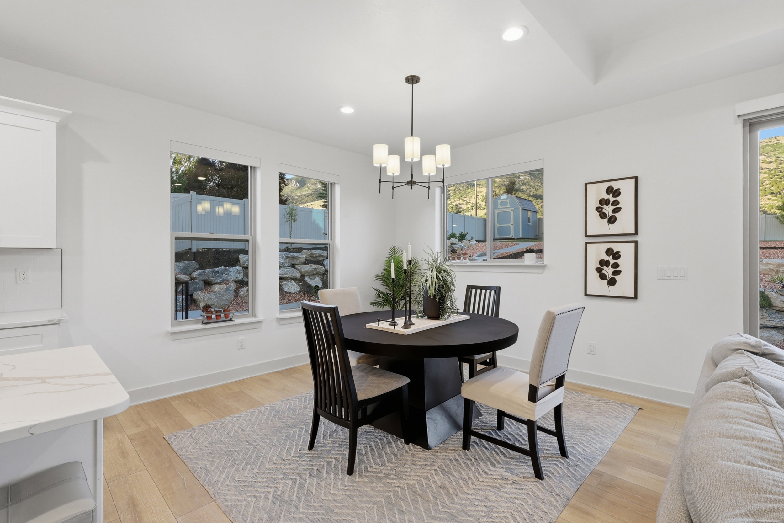 Dining area featuring light wood-finish flooring and a contemporary chandelier