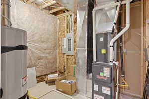 Mechanical room featuring an everscent diffusion system, water heater, insta-hotwater, furnace, electrical panel, Soft water system, and exposed ductwork