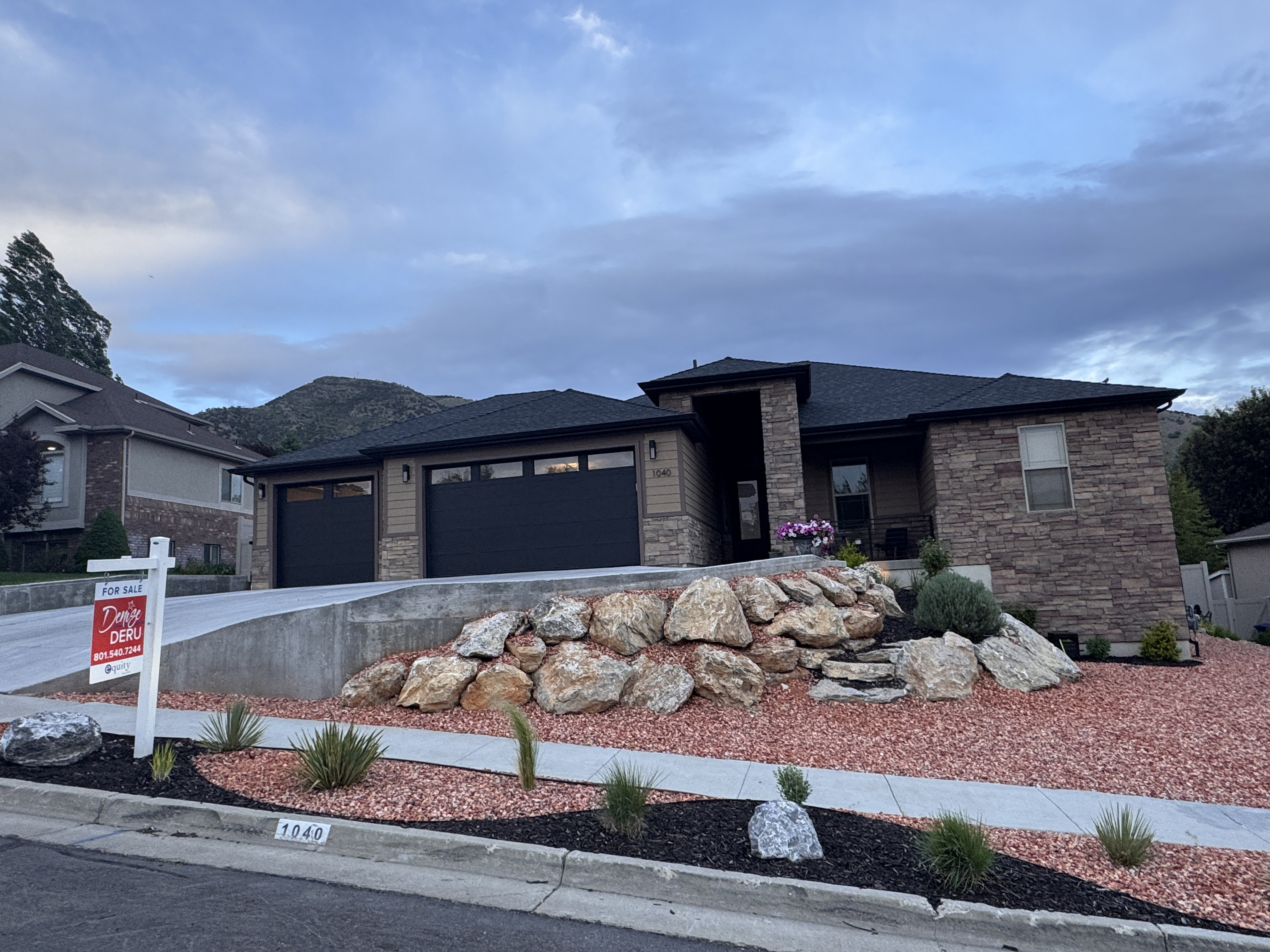 Contemporary home exterior featuring a stone and siding facade