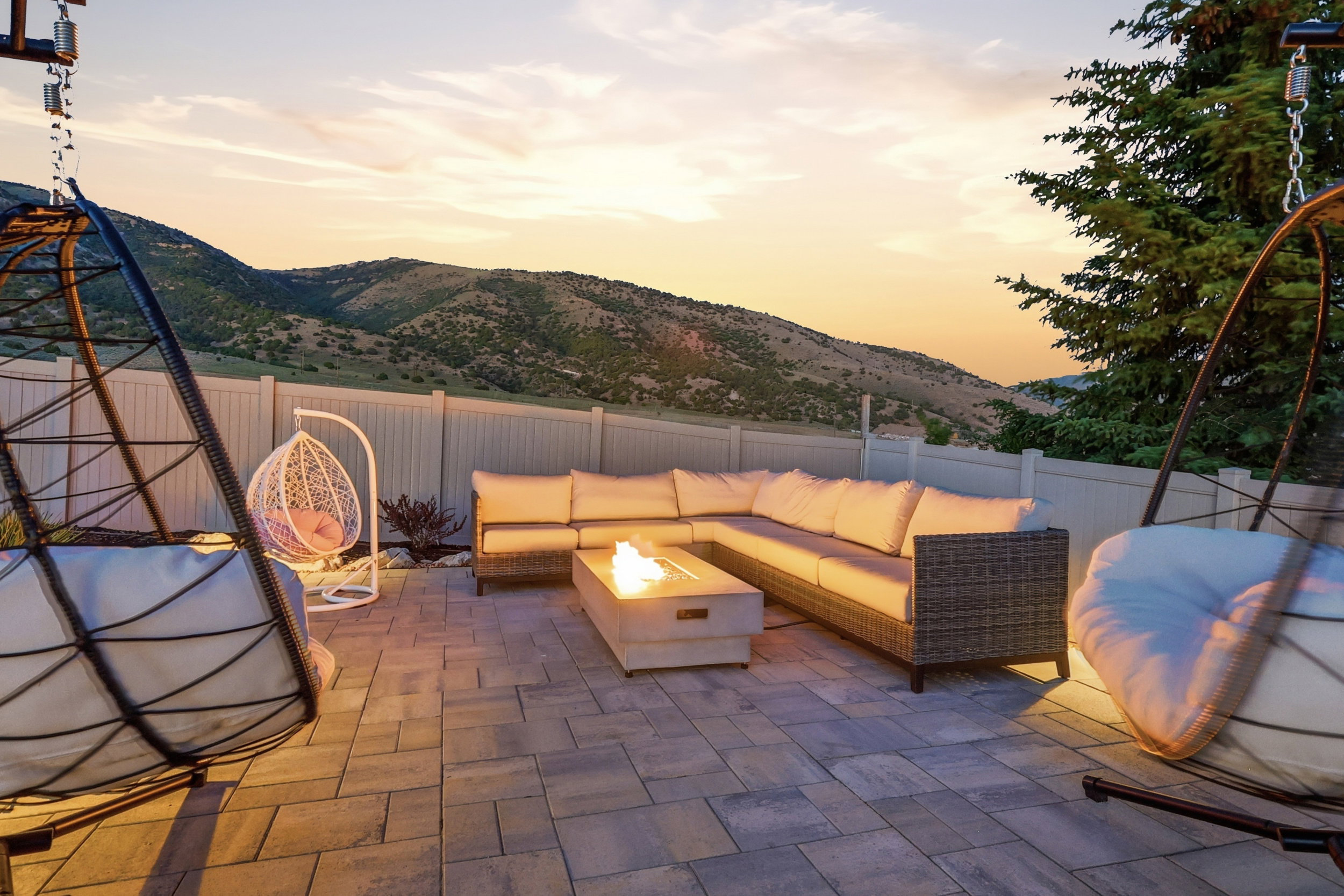 Paver patio with an integrated fire pit, providing a distinct outdoor living space