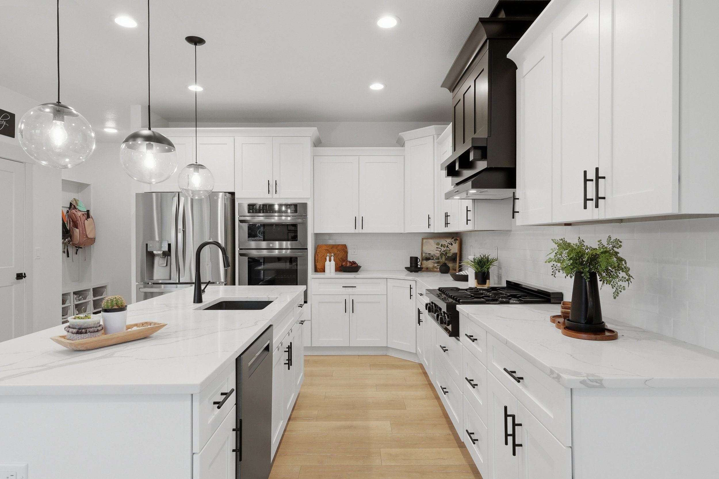 Contemporary kitchen with a spacious island featuring a black sink and matte black faucet