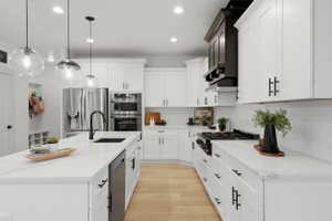 Contemporary kitchen with a spacious island featuring a black sink and matte black faucet