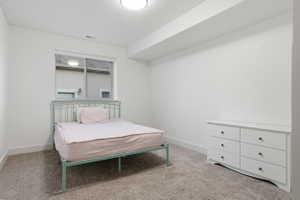 #6 Carpeted room with a ceiling light fixture, white walls, and a single window