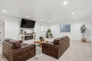 Spacious room featuring light-colored carpeting, recessed lighting, and a window with horizontal blinds