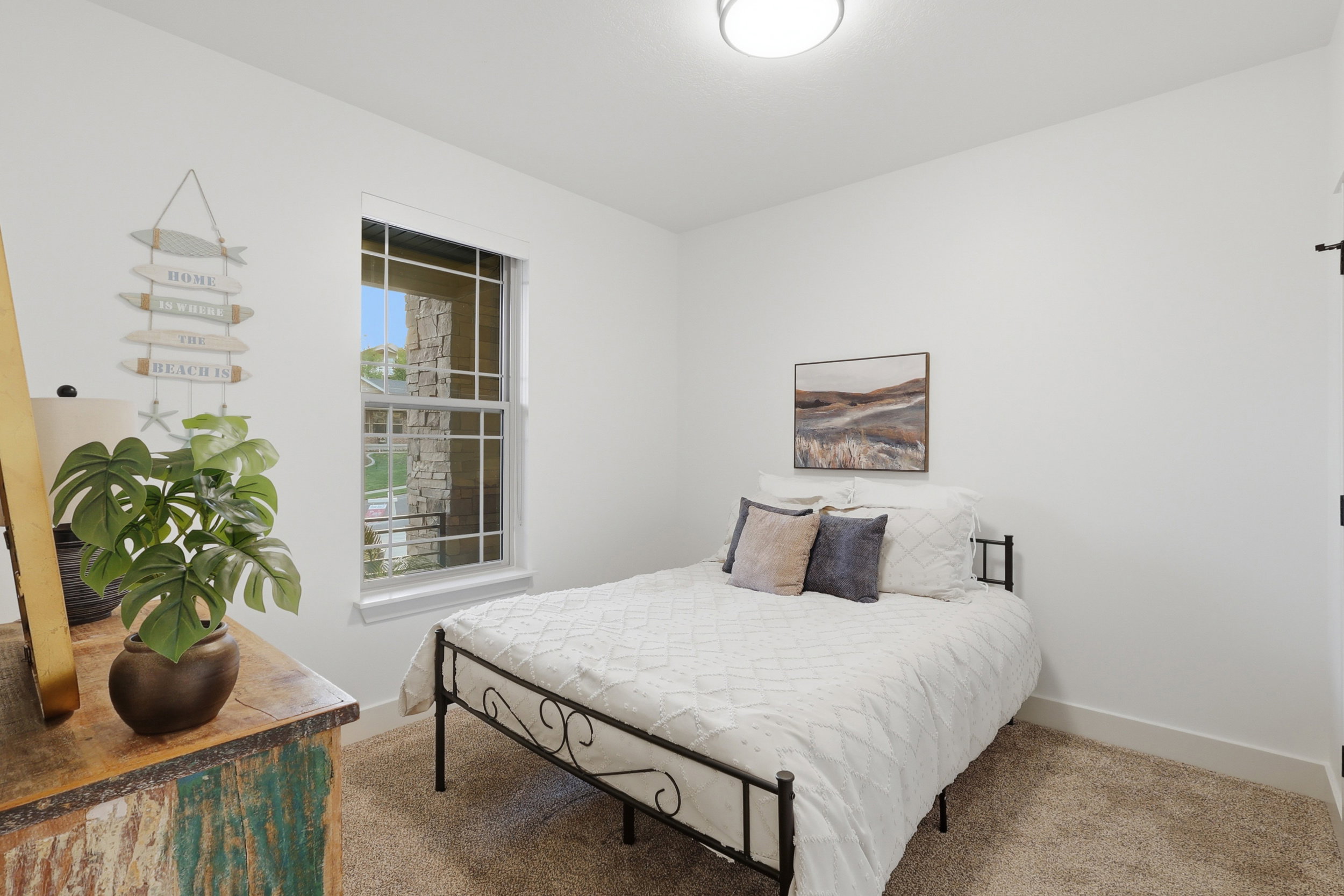 #2 Bright room featuring a grid window, neutral carpeting, and a flush-mount ceiling light fixture
