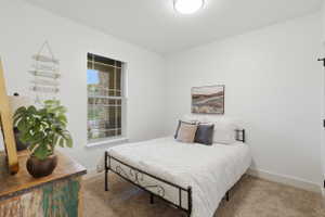 #2 Bright room featuring a grid window, neutral carpeting, and a flush-mount ceiling light fixture