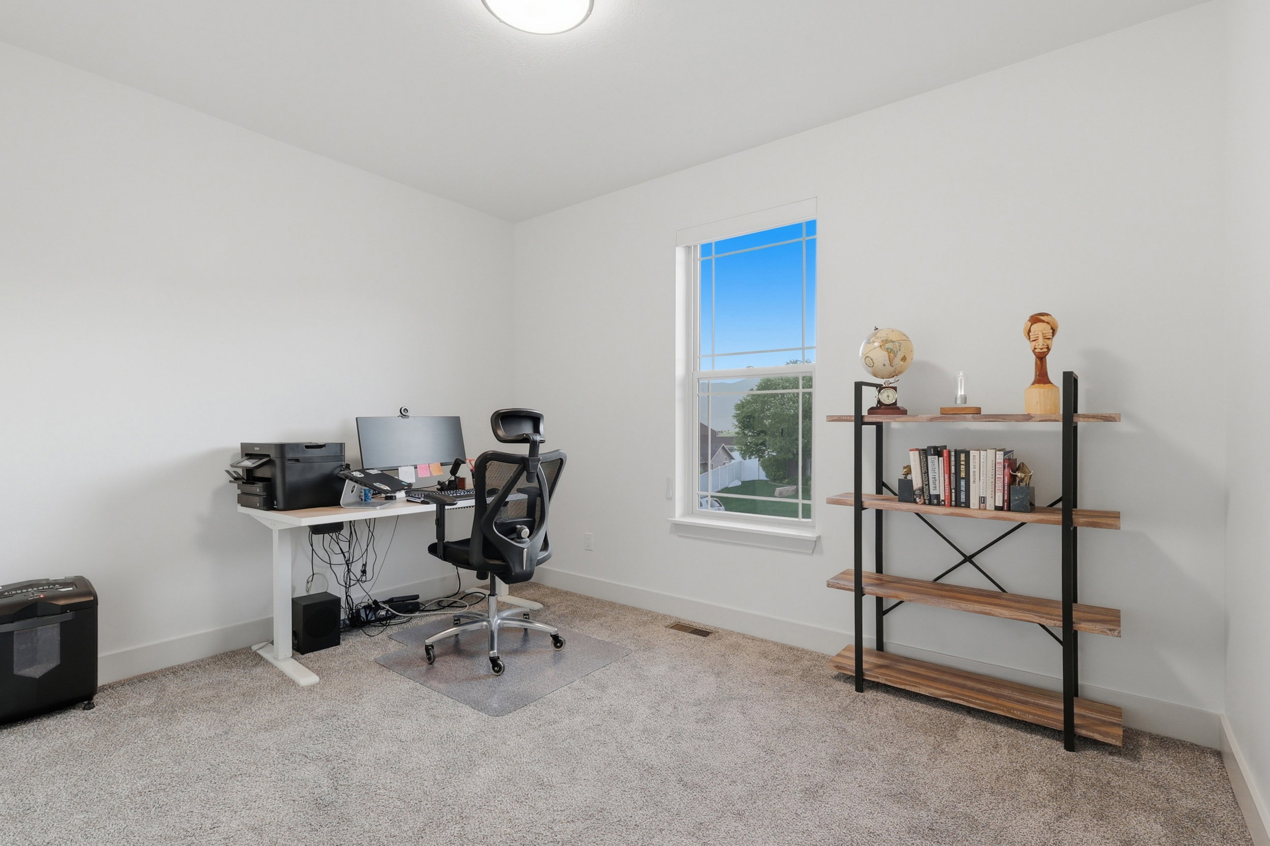 #3 Room featuring a large window, light-colored walls, and neutral carpet flooring