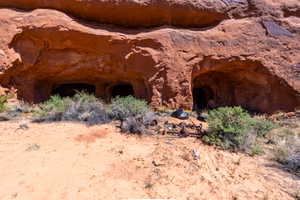 Red rock formation featuring multiple cave entrances