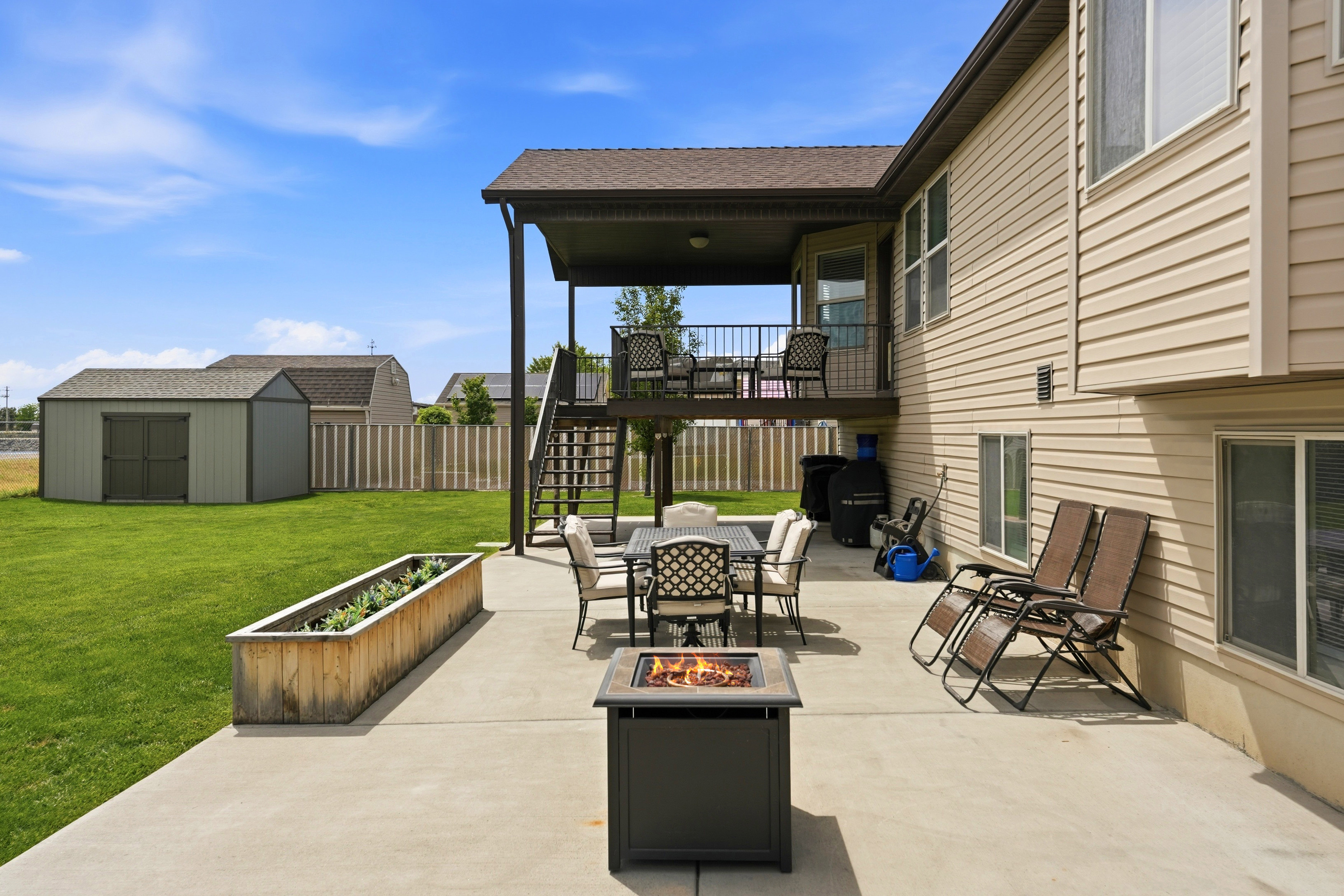 Expansive concrete patio with a covered upper deck
