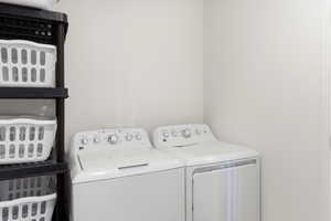 Laundry area featuring white walls and a white top-load washer and dryer set