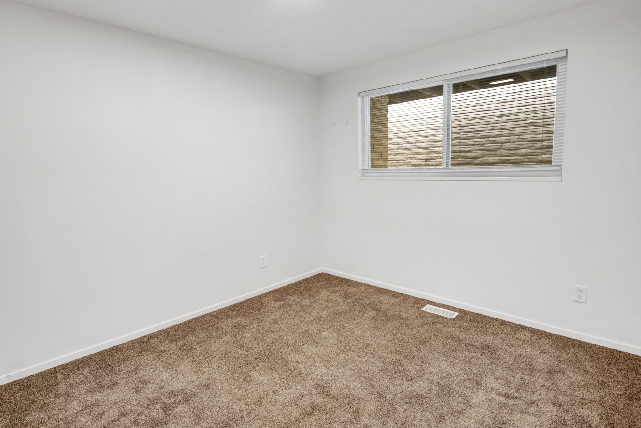 Neutral color palette with white walls and brown carpeting