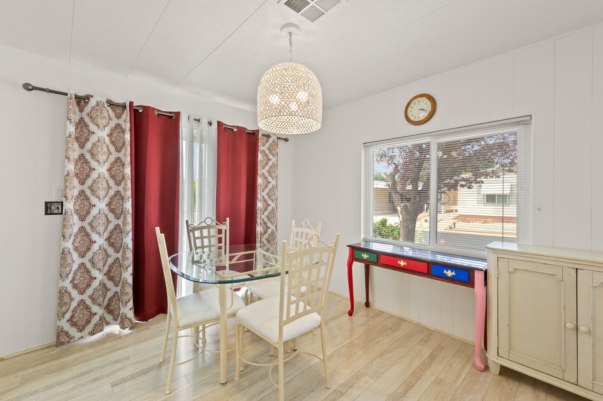 Dining area featuring wood-finish flooring, a large window, and a built-in ceiling light fixture