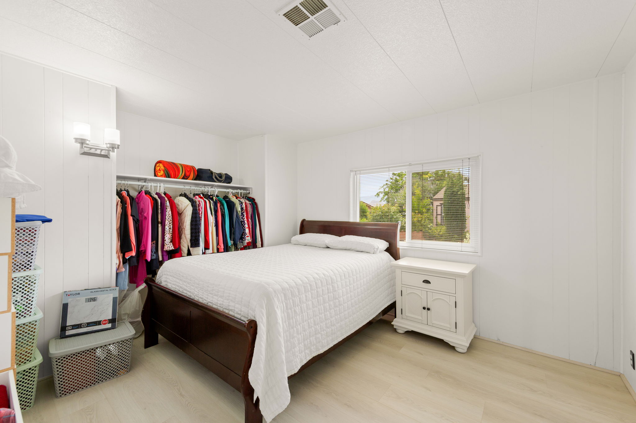 Room featuring light wood-finish flooring and white vertical paneling