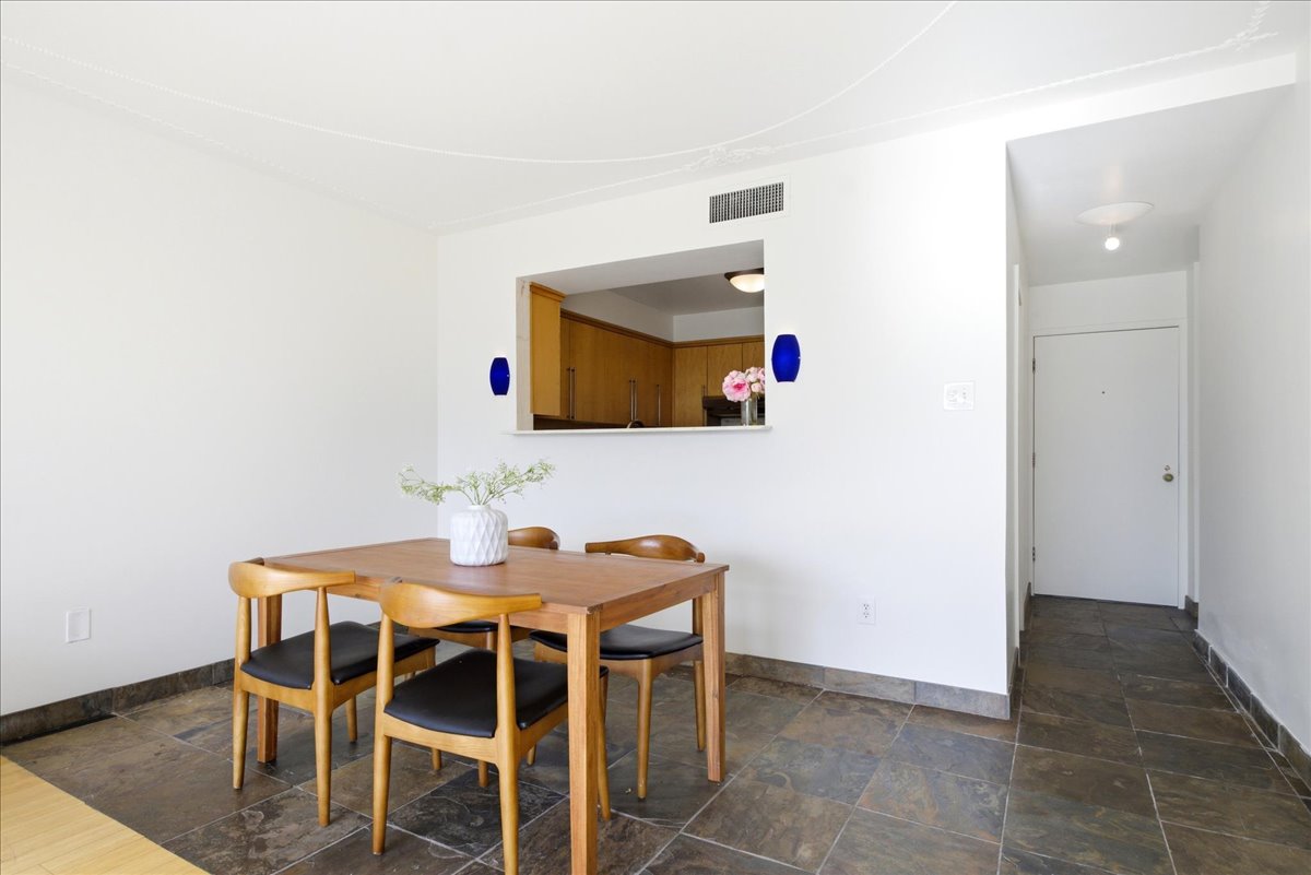 Dining area featuring a pass-through window to the kitchen