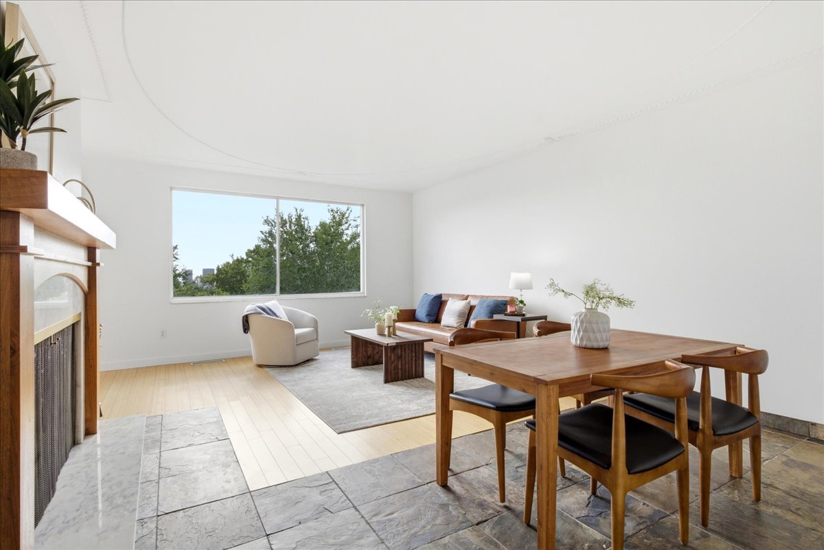 Open-concept living area with a large window providing ample natural light