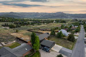 Expansive mountain scenery framing a residential area with varied architectural styles
