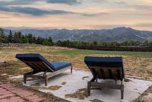 Expansive outdoor space featuring a large lawn area and a mountain backdrop