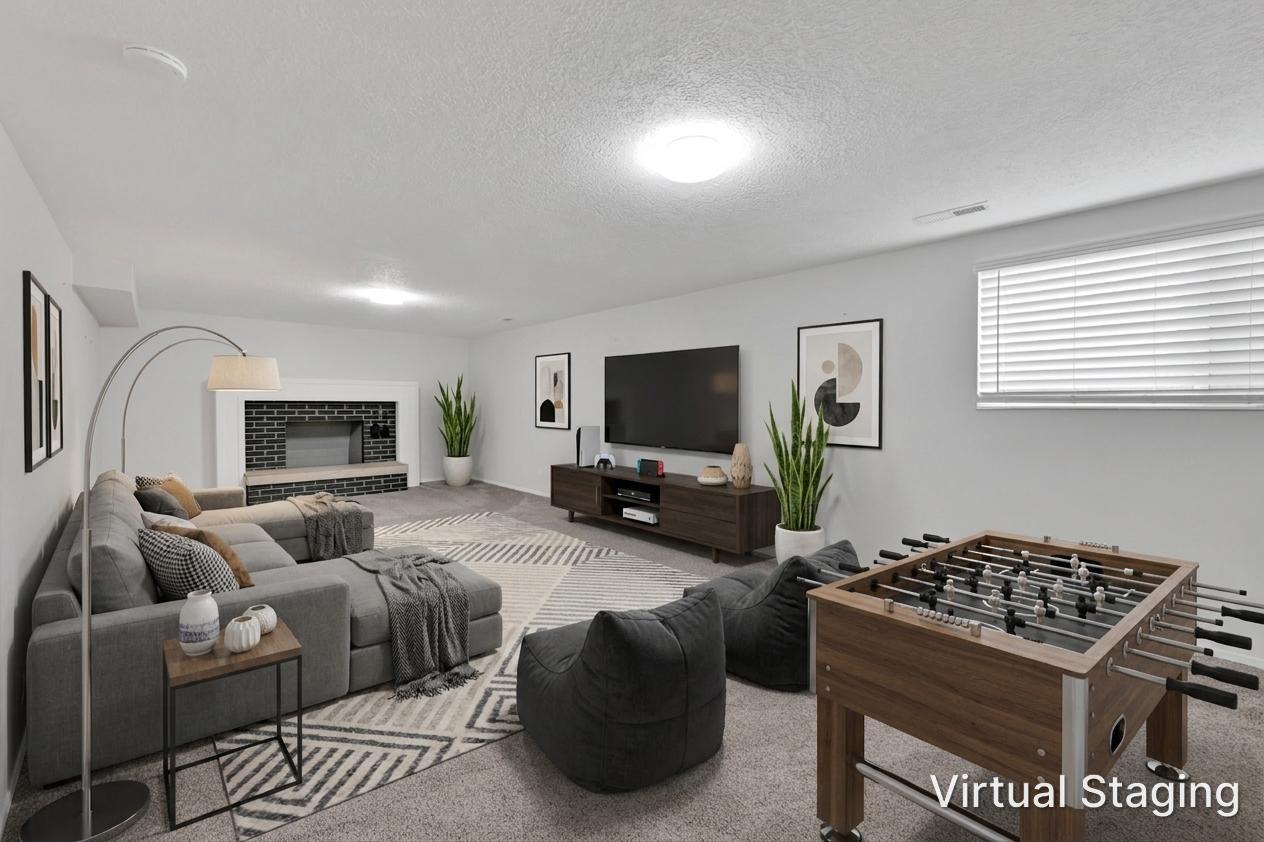 Spacious recreational area featuring a fireplace with a dark brick facade and a wide hearth. Room was virtually staged.