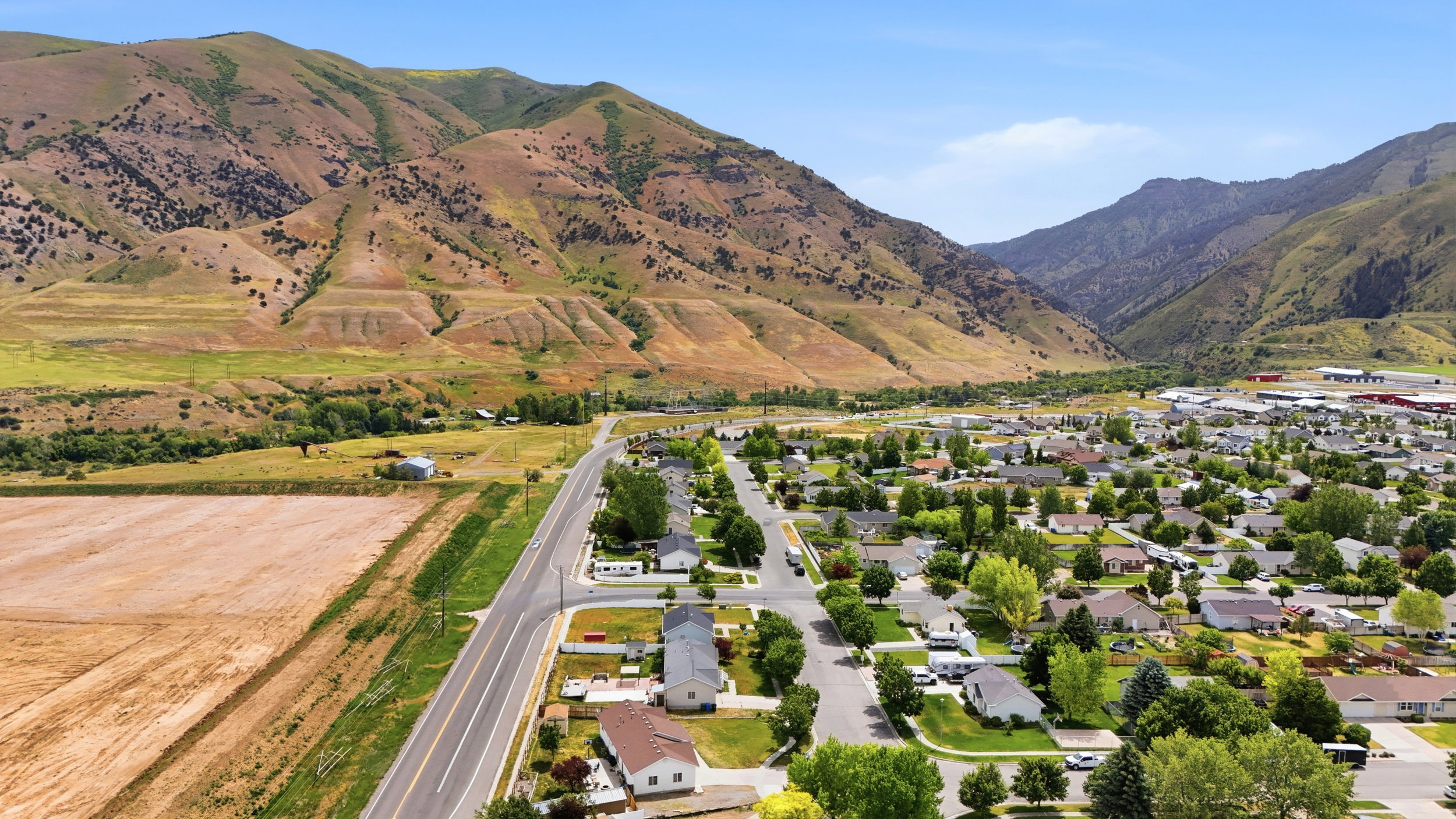 Expansive valley setting with residential area surrounded by mountainous terrain