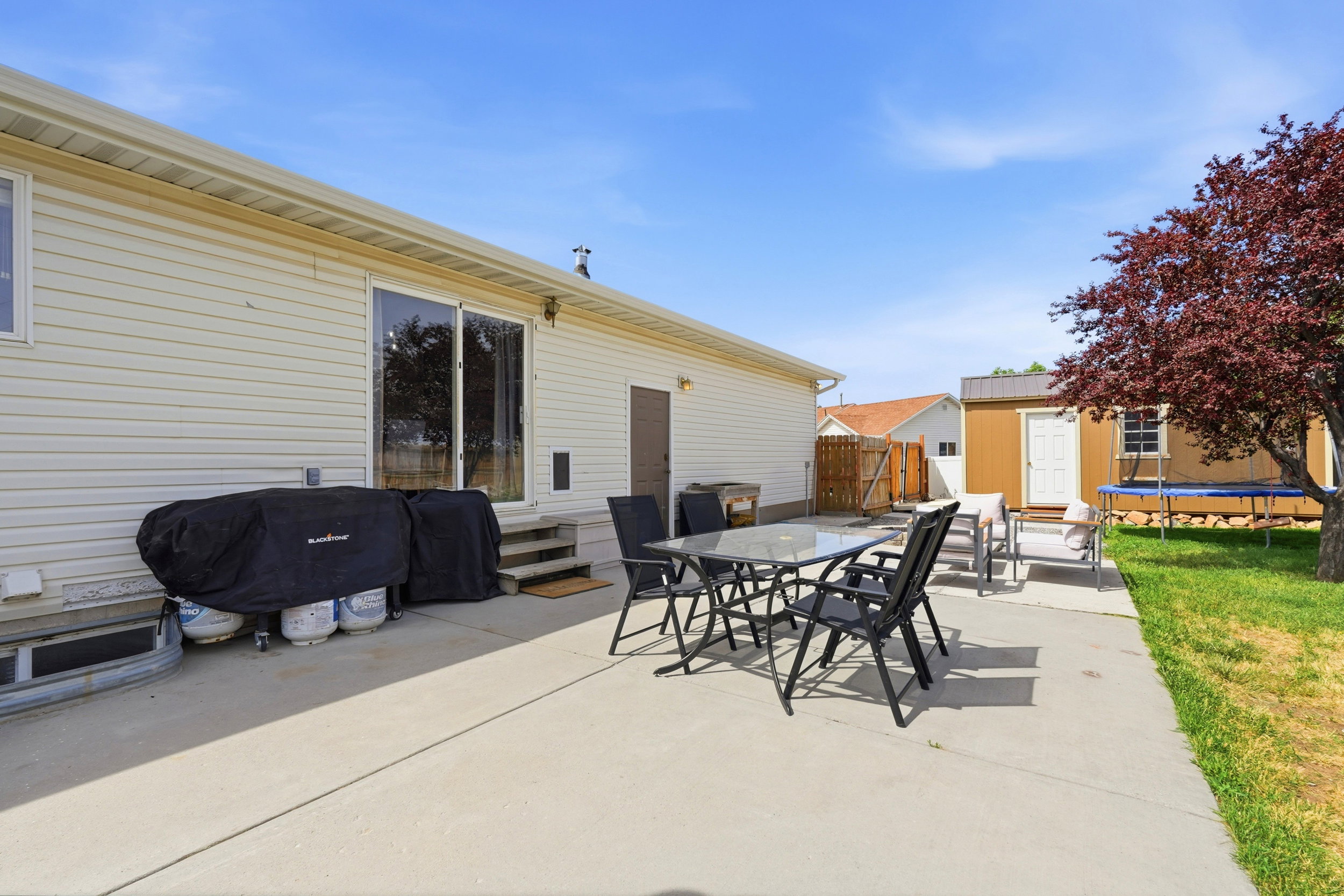 Expansive concrete patio area offering direct access via sliding glass doors