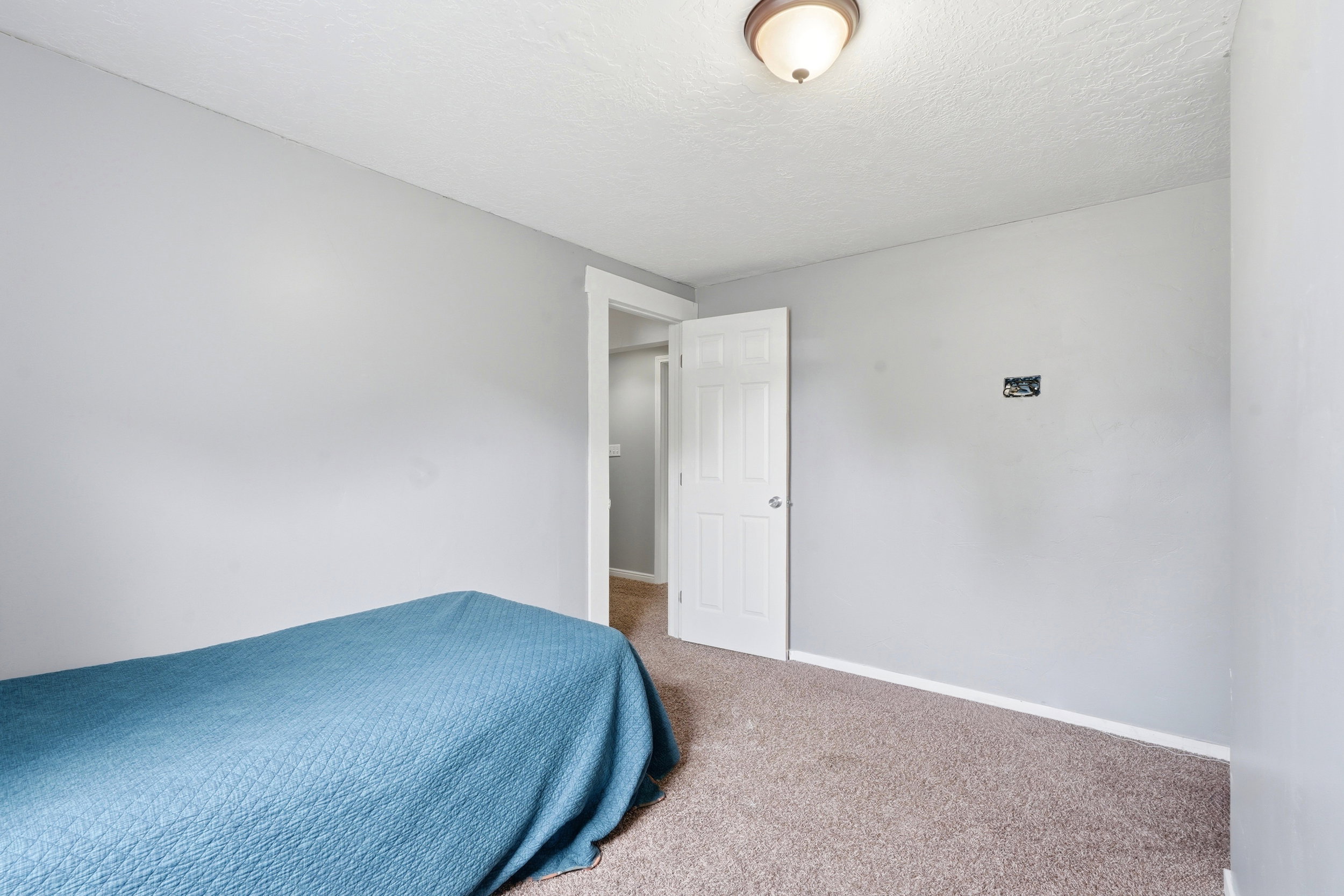 Interior room with light gray walls, white trim, and a white paneled door