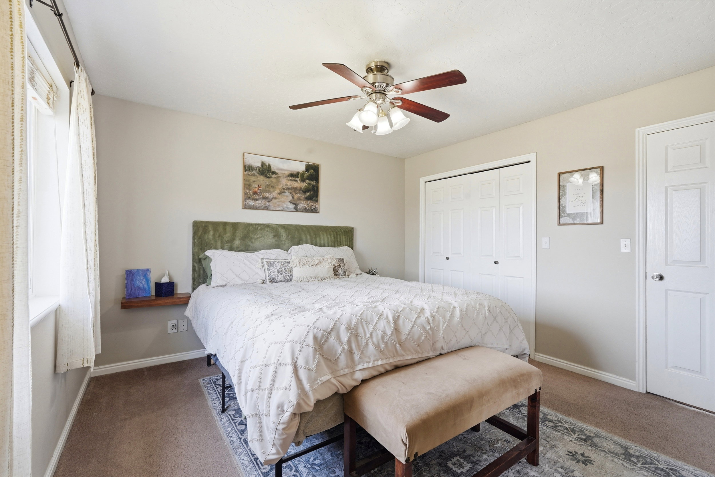 Neutral-toned walls complement the brown carpet flooring