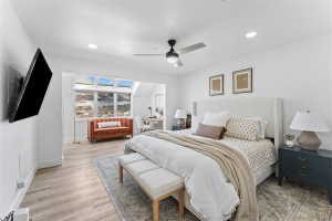 Spacious room featuring wood-finish flooring, recessed lighting, and a ceiling fan