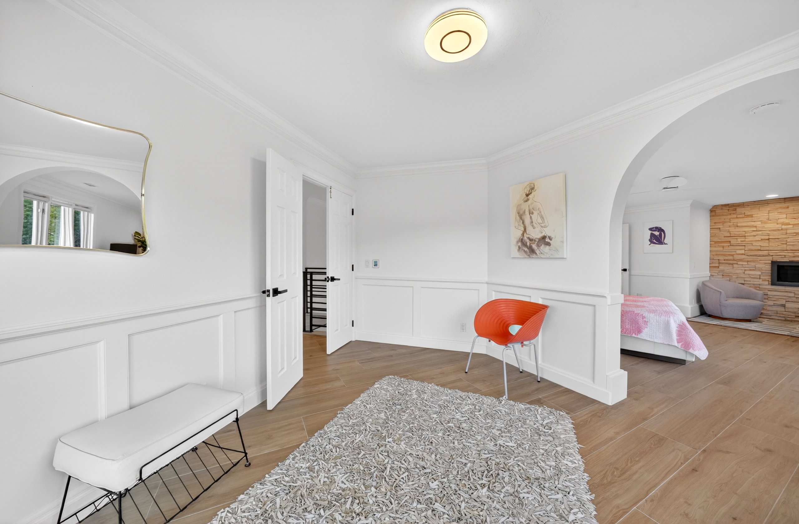 Interior hallway featuring wainscoting, crown molding, and wood-finish flooring