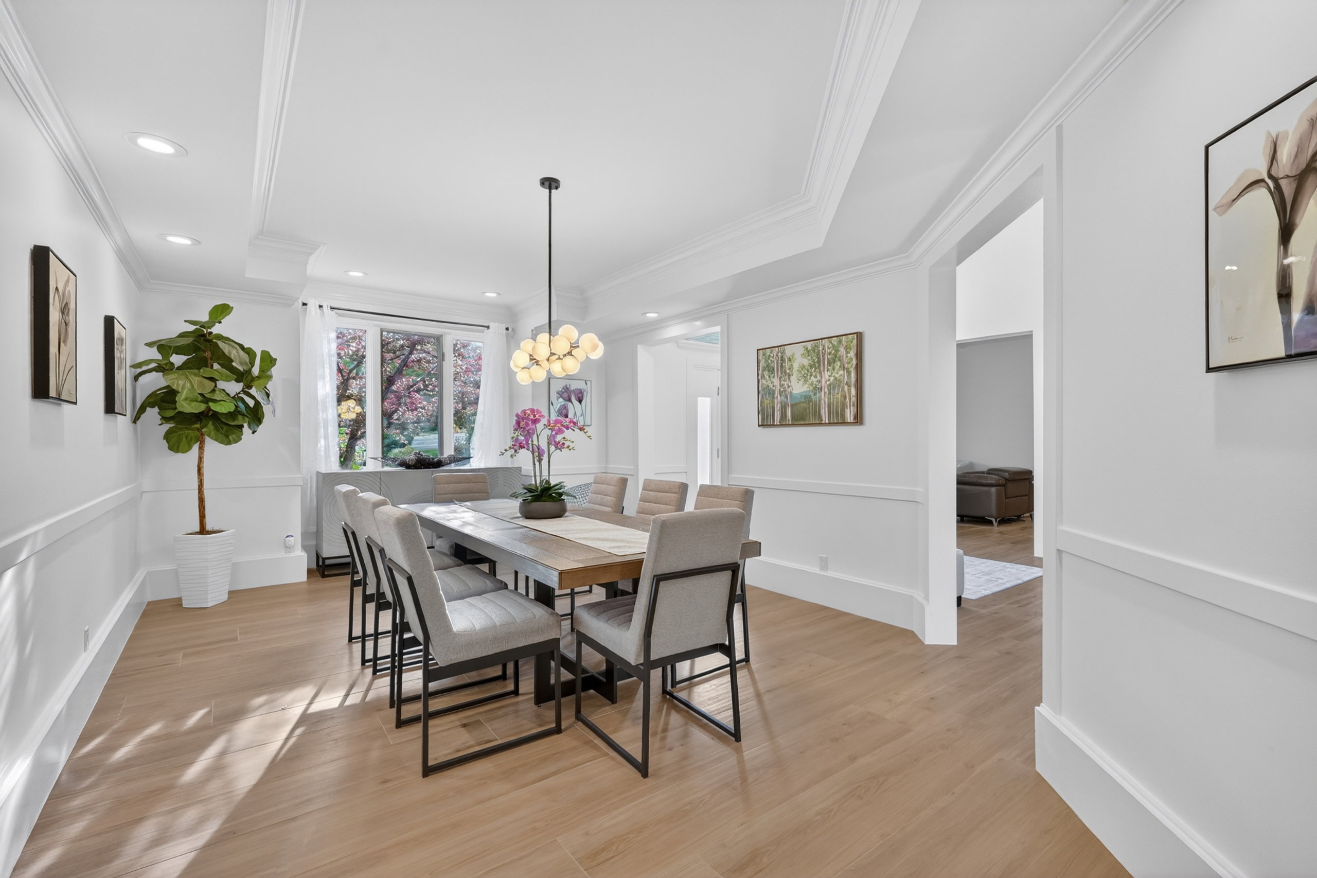 Formal dining space featuring recessed lighting, a multi-globe chandelier, wood-finish flooring, wainscoting, and crown molding