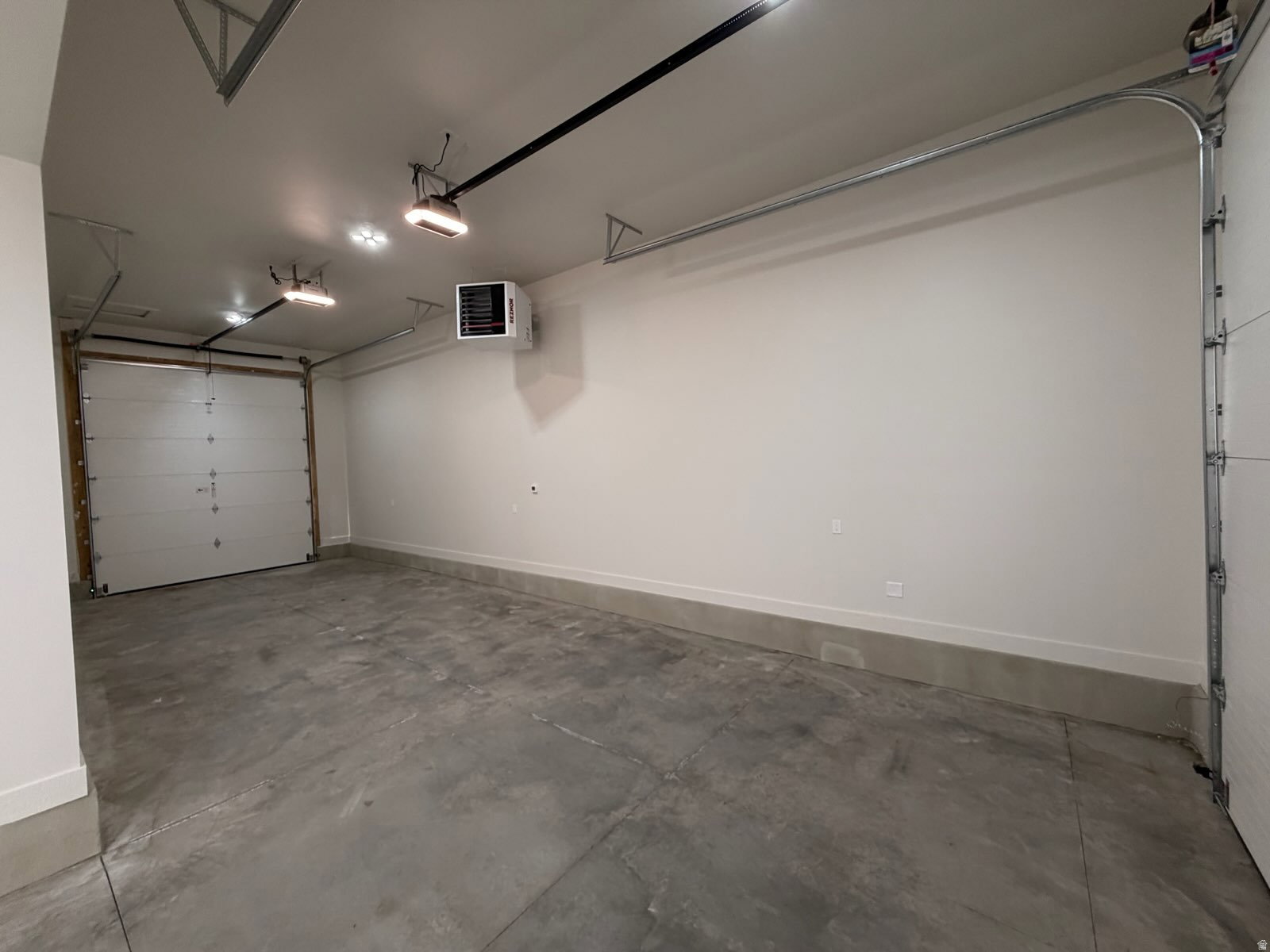 Garage with a heating unit and a garage door opener