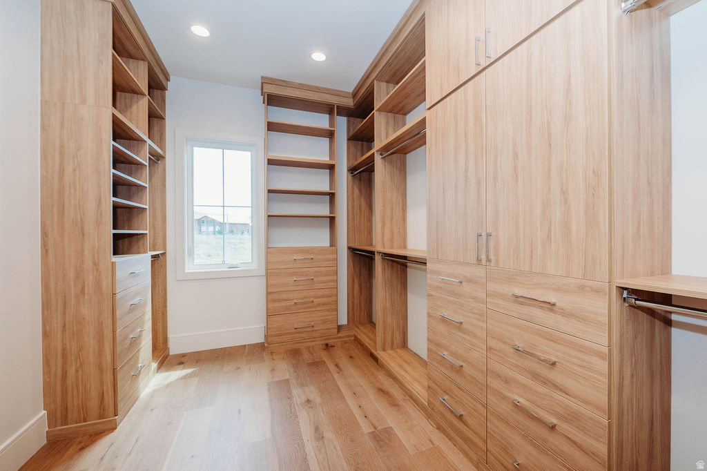 Walk-in closet with upgraded cabinetry and window