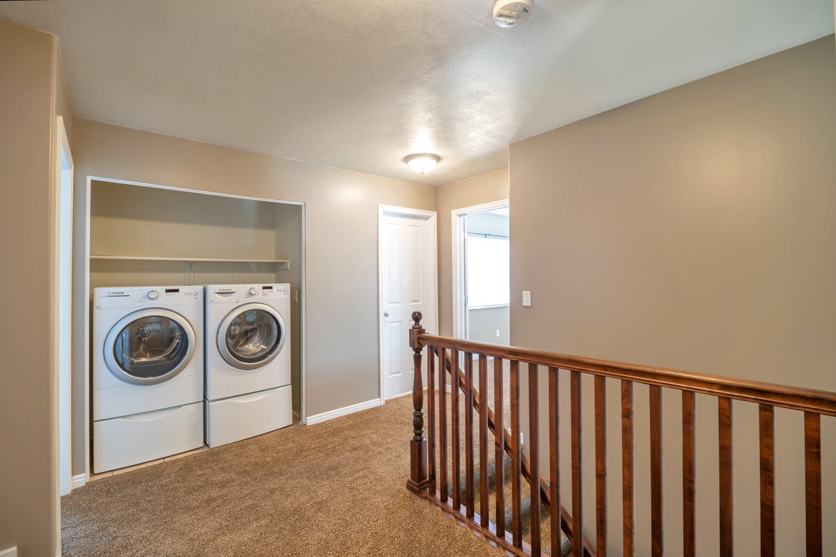 Dedicated laundry area featuring front-loading washer and dryer units