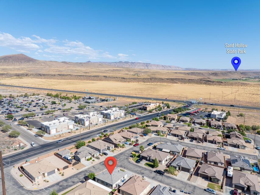 Aerial perspective showcasing a residential neighborhood with surrounding desert landscape and distant mountains