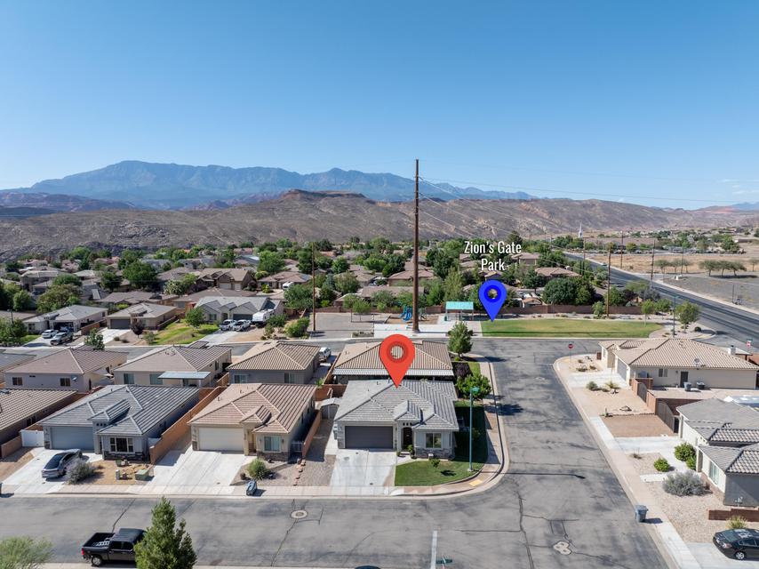 Aerial view showcasing a residential neighborhood with mountain backdrops