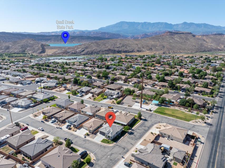 Aerial view of a residential neighborhood with arid mountain ranges in the background