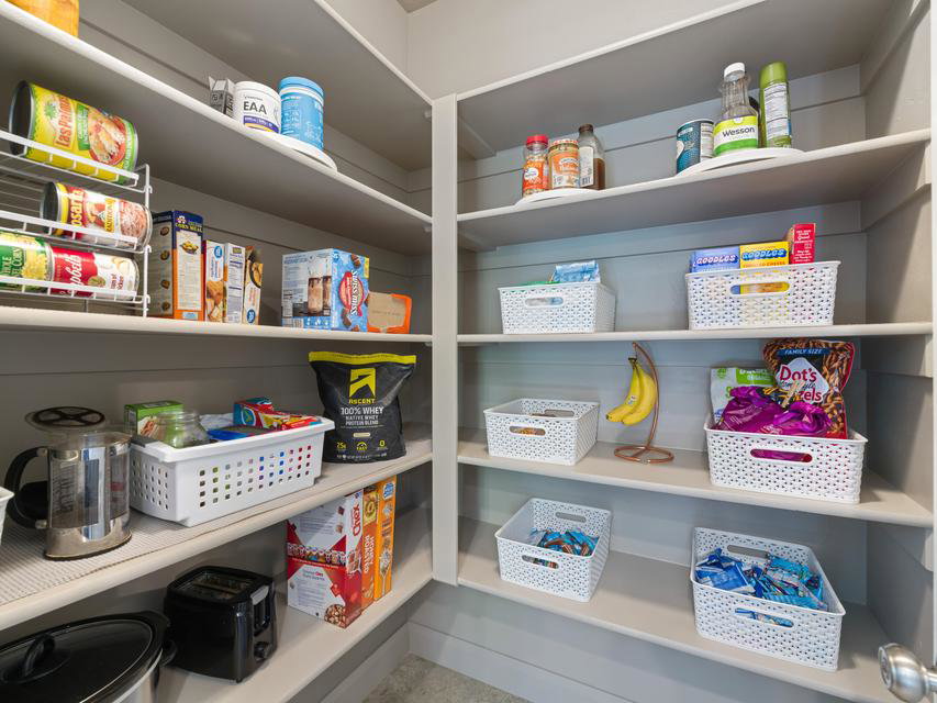 Corner pantry with multiple built-in shelves, offering ample storage