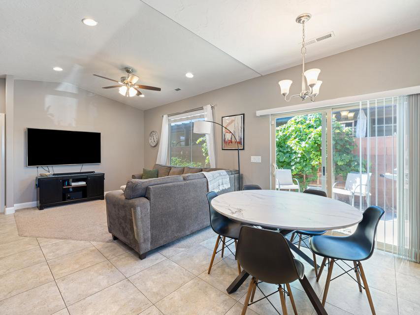 Open-concept living and dining area featuring tile flooring, recessed lighting, and a ceiling fan