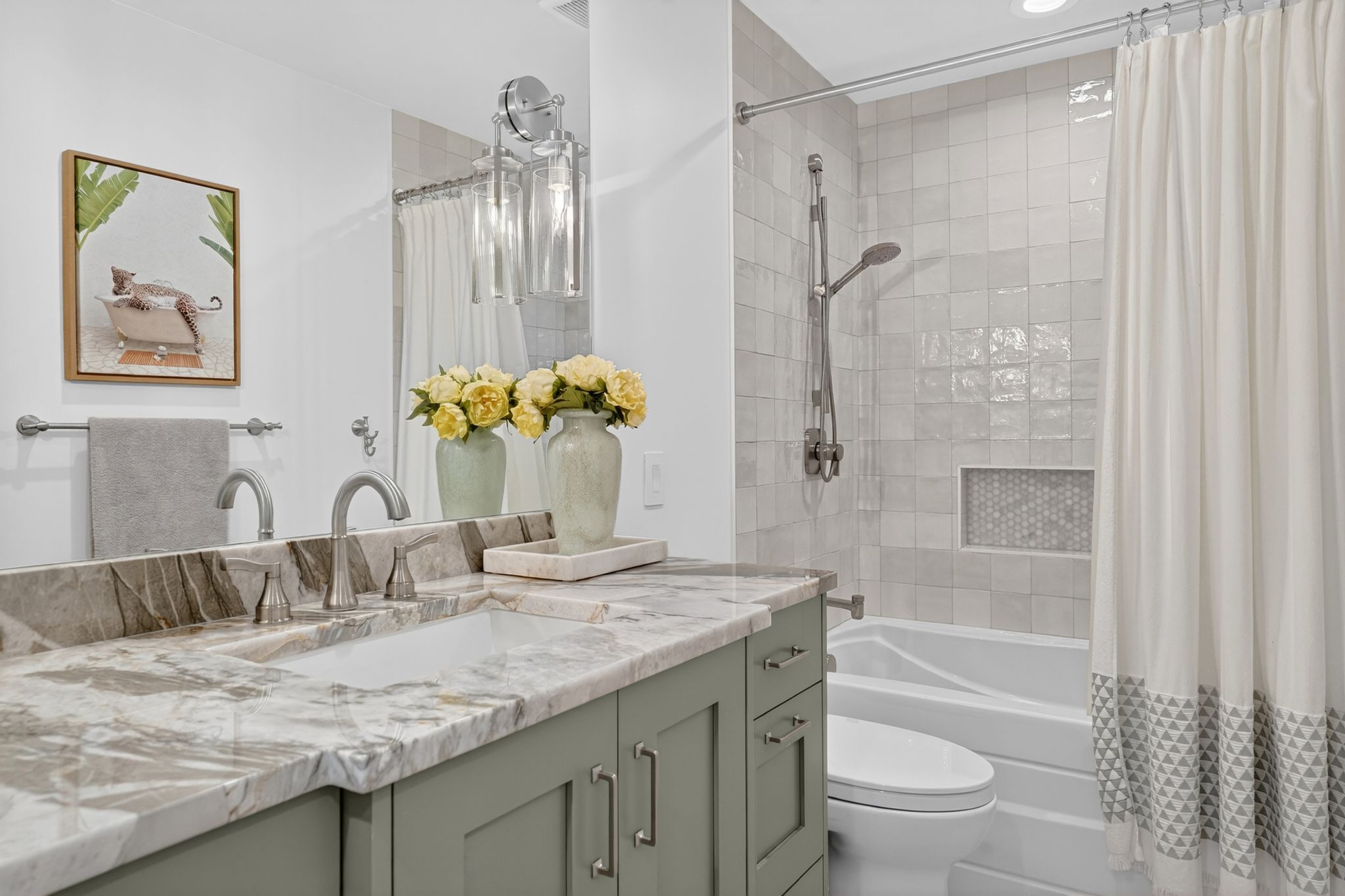 Modern bathroom featuring a double vanity with a stone countertop, undermount sinks, and brushed nickel faucets