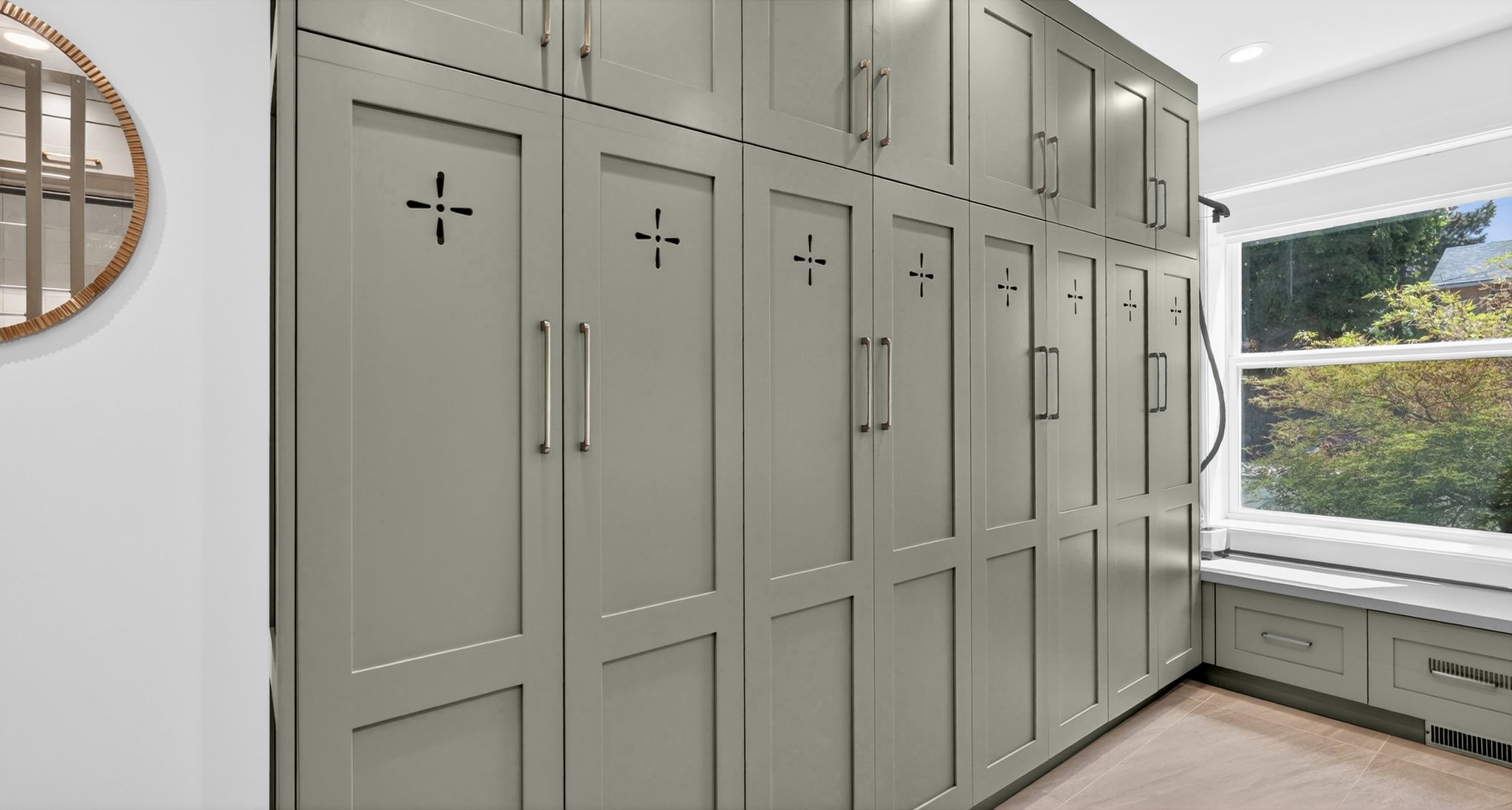 Floor-to-ceiling cabinetry with custom cut-out details and metal hardware